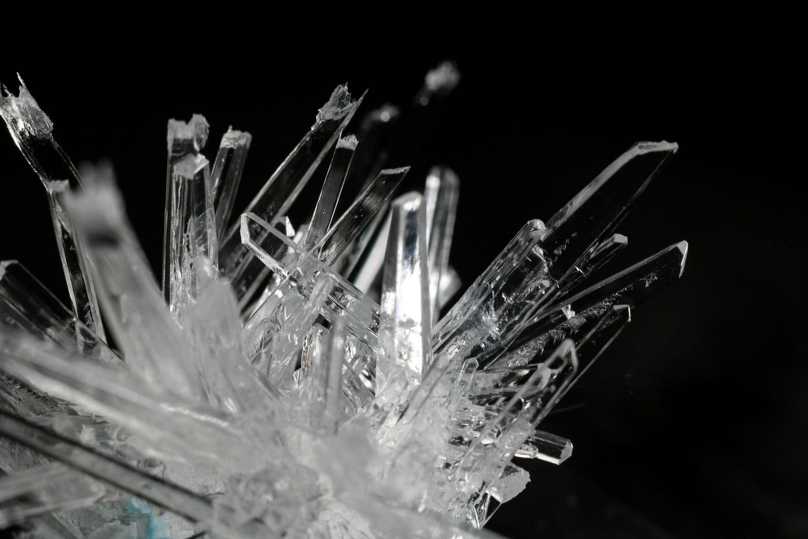 Close-up of clear, sharp crystals against a black background