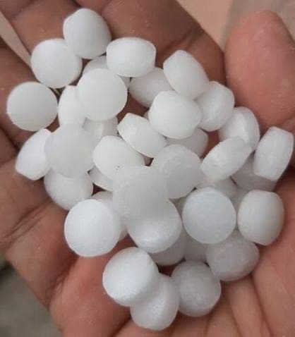 A palm full of round white V-BOSS camphor tablets